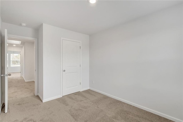 unfurnished bedroom with baseboards, recessed lighting, and light colored carpet