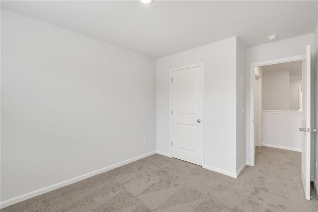 unfurnished bedroom featuring carpet floors and baseboards