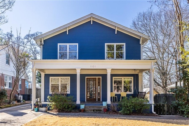 view of front facade featuring covered porch and fence