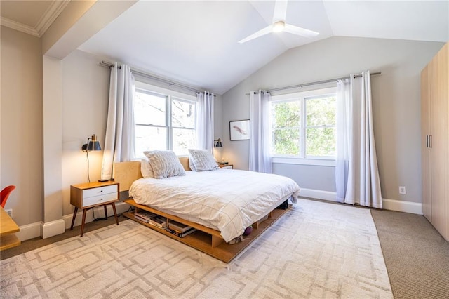 bedroom featuring lofted ceiling, multiple windows, baseboards, and light colored carpet