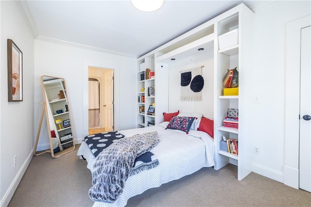 carpeted bedroom featuring baseboards and ornamental molding