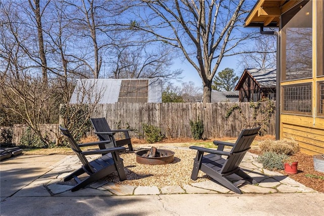 view of patio featuring a fire pit and fence