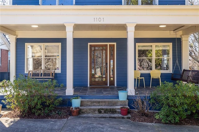 view of exterior entry with a porch