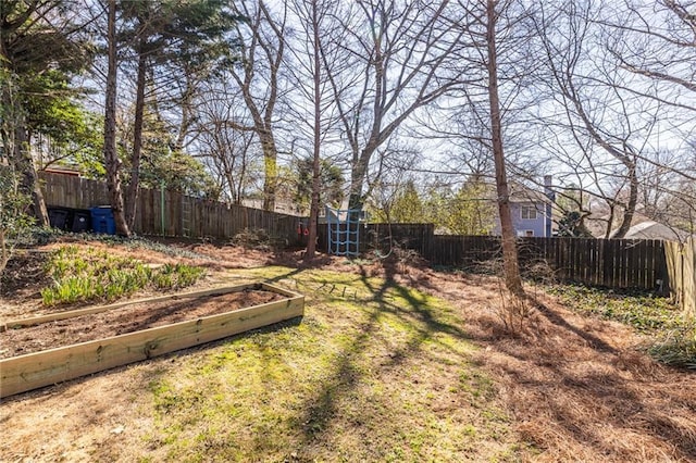 view of yard featuring a fenced backyard and a vegetable garden