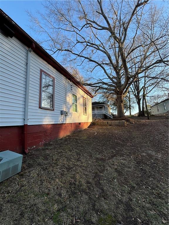 view of side of home with crawl space