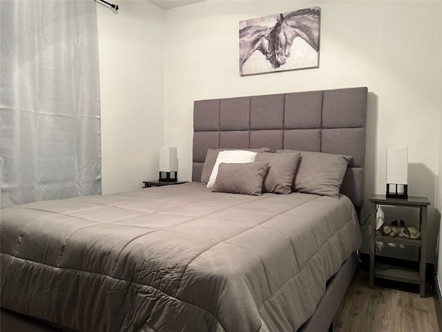 bedroom with wood finished floors