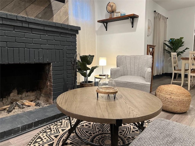 living area with a fireplace and wood finished floors