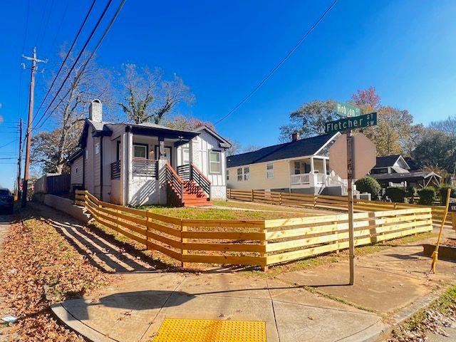 view of front of property with a fenced front yard and a chimney