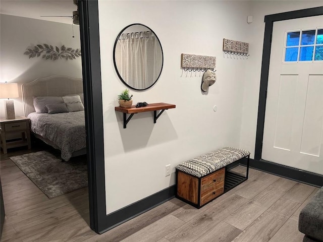 foyer entrance with ceiling fan, light wood-type flooring, and baseboards