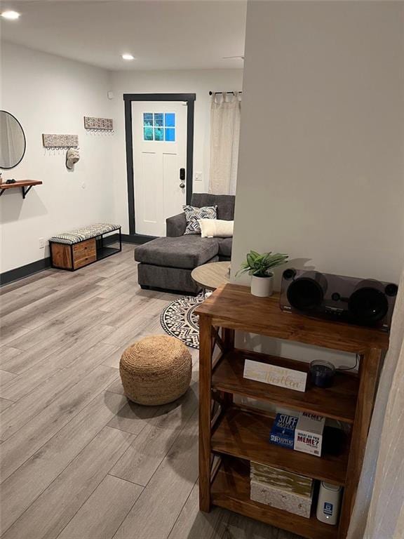 living area with recessed lighting, wood finished floors, and baseboards