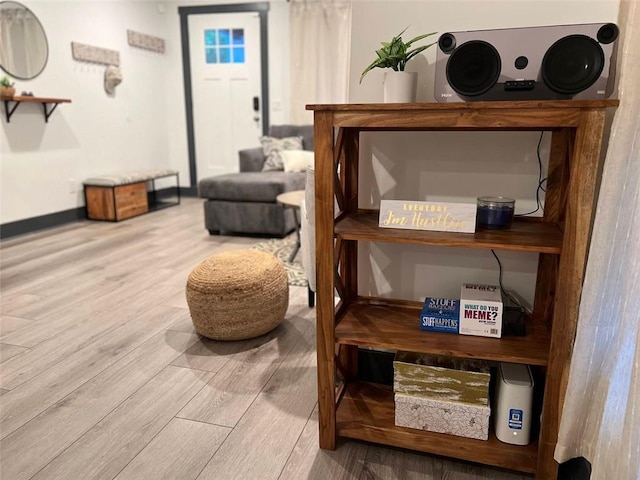 interior space with baseboards and wood finished floors