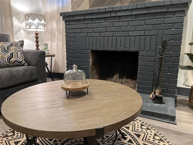 dining area featuring a fireplace and wood finished floors