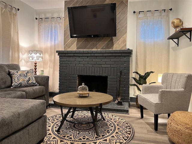 sitting room featuring a fireplace and wood finished floors