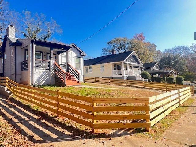 exterior space with a chimney and fence