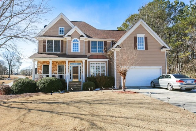 view of front of house featuring a garage, a porch, and a front lawn