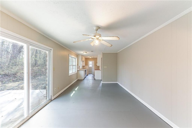 interior space featuring ornamental molding, concrete floors, baseboards, and ceiling fan