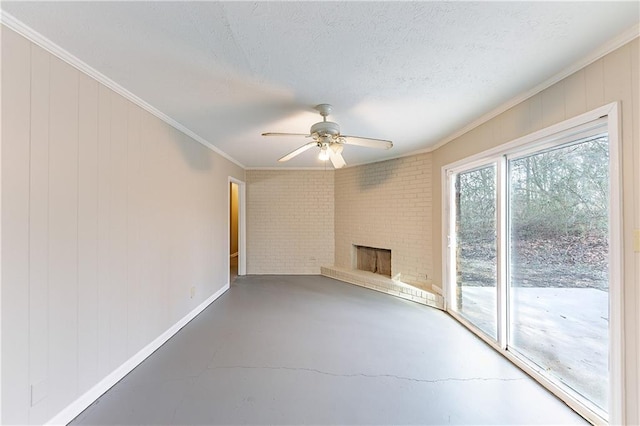 unfurnished living room featuring ornamental molding, a brick fireplace, ceiling fan, and a textured ceiling