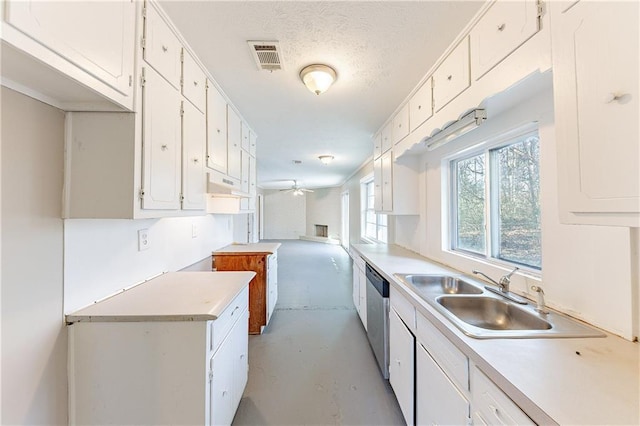 kitchen featuring a sink, open floor plan, light countertops, finished concrete flooring, and dishwasher