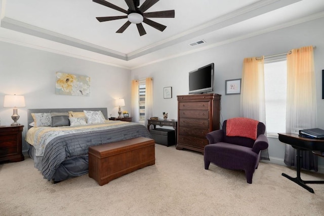 bedroom featuring a raised ceiling, visible vents, crown molding, and light carpet