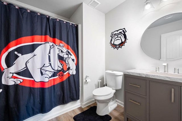 full bathroom featuring visible vents, vanity, toilet, and wood finished floors