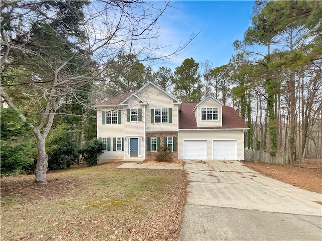 view of front of home featuring a front yard and a garage