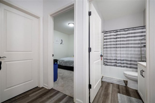 155 Knightsbridge Ln, Winder, GA 30680 - full bathroom featuring wood finished floors, vanity, shower / tub combo with curtain, and toilet