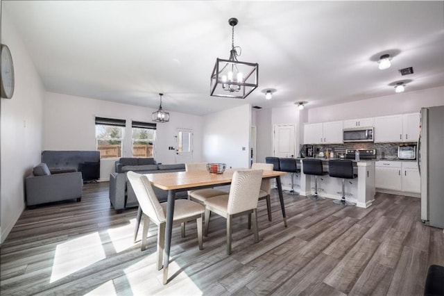 155 Knightsbridge Ln, Winder, GA 30680 - dining area featuring a chandelier and wood finished floors