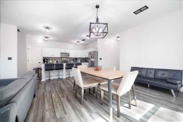 155 Knightsbridge Ln, Winder, GA 30680 - dining room featuring a chandelier and light wood-style floors