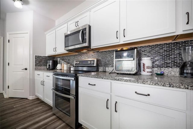 155 Knightsbridge Ln, Winder, GA 30680 - kitchen with appliances with stainless steel finishes, white cabinetry, decorative backsplash, dark wood-style floors, and stone countertops