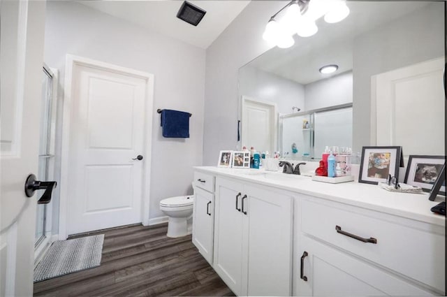 155 Knightsbridge Ln, Winder, GA 30680 - full bathroom featuring a stall shower, wood finished floors, vanity, and toilet