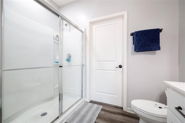 155 Knightsbridge Ln, Winder, GA 30680 - full bathroom featuring a shower stall, wood finished floors, toilet, vanity, and baseboards