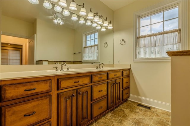 bathroom with ceiling fan and vanity