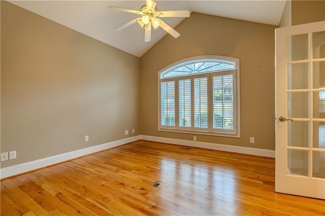 unfurnished room with ceiling fan, light hardwood / wood-style floors, and vaulted ceiling