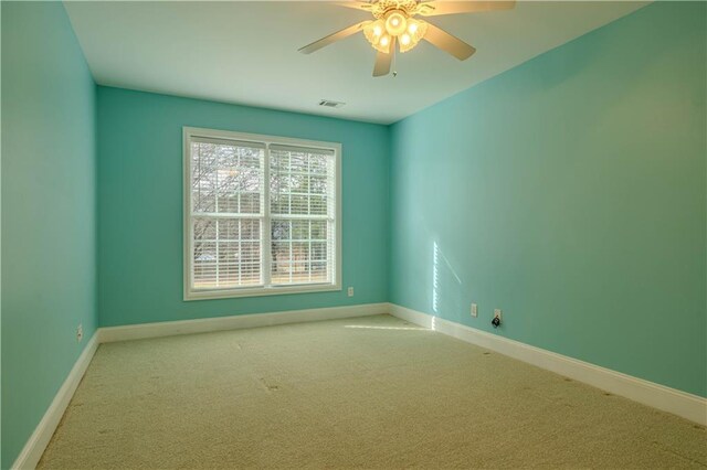 carpeted empty room featuring ceiling fan