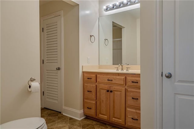 bathroom featuring tile patterned flooring, vanity, and toilet