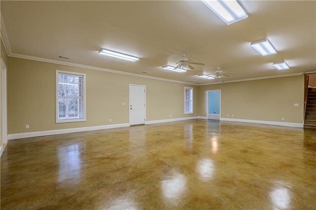 spare room featuring concrete floors, ceiling fan, and ornamental molding