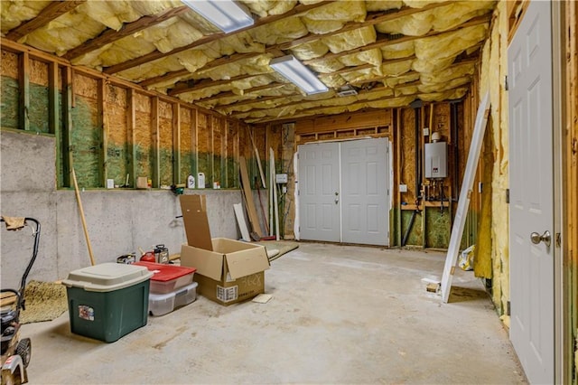 misc room with concrete floors and water heater