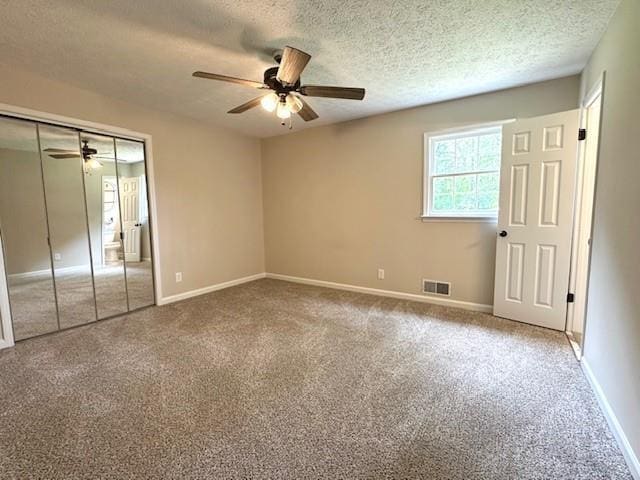 942 Batesville Rd, Canton, GA 30115 - unfurnished bedroom with a textured ceiling, carpet, baseboards, a closet, and a ceiling fan