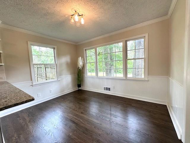 942 Batesville Rd, Canton, GA 30115 - unfurnished dining area with a textured ceiling, wood finished floors, a wainscoted wall, and ornamental molding