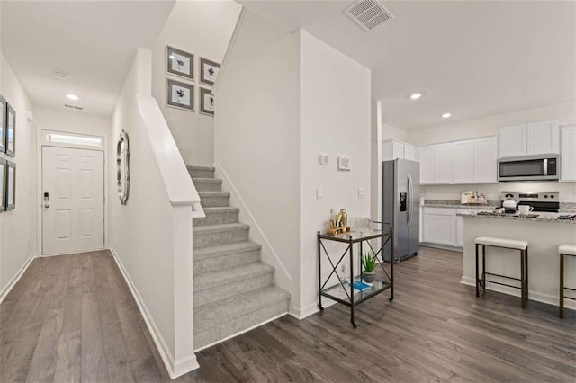 1315 Aura Ln, Lawrenceville, GA 30045 - entrance foyer with dark wood-style floors, recessed lighting, and stairs