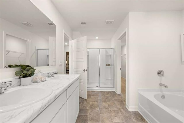1315 Aura Ln, Lawrenceville, GA 30045 - full bathroom featuring a spacious closet, a stall shower, double vanity, a garden tub, and recessed lighting