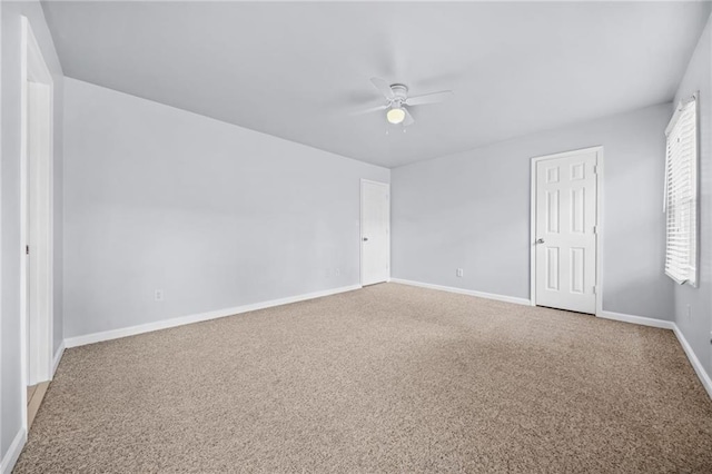 empty room with ceiling fan and carpet flooring