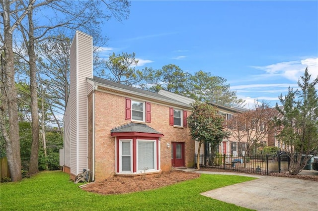 view of front of home featuring a front lawn and a patio