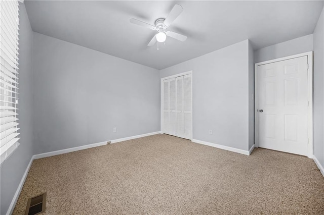 unfurnished bedroom with multiple windows, carpet flooring, and a closet