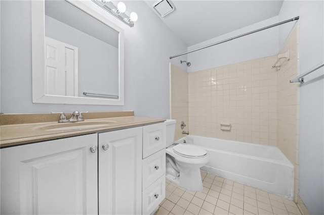 full bathroom with tile patterned floors, vanity, toilet, and tiled shower / bath combo