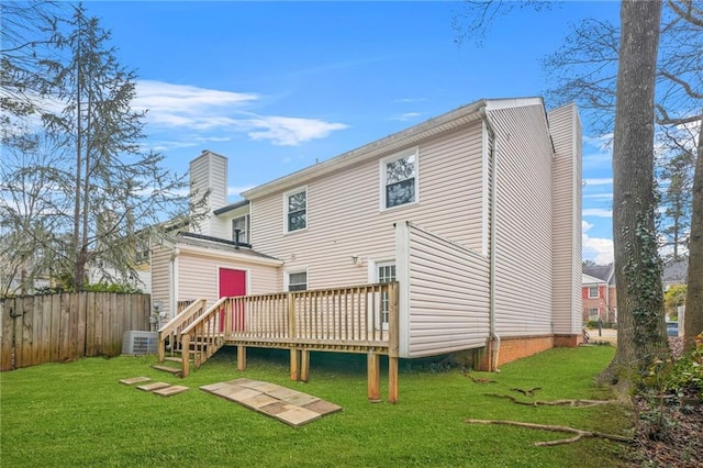 rear view of property with a yard, central AC, and a deck