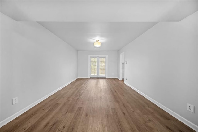 spare room featuring wood-type flooring