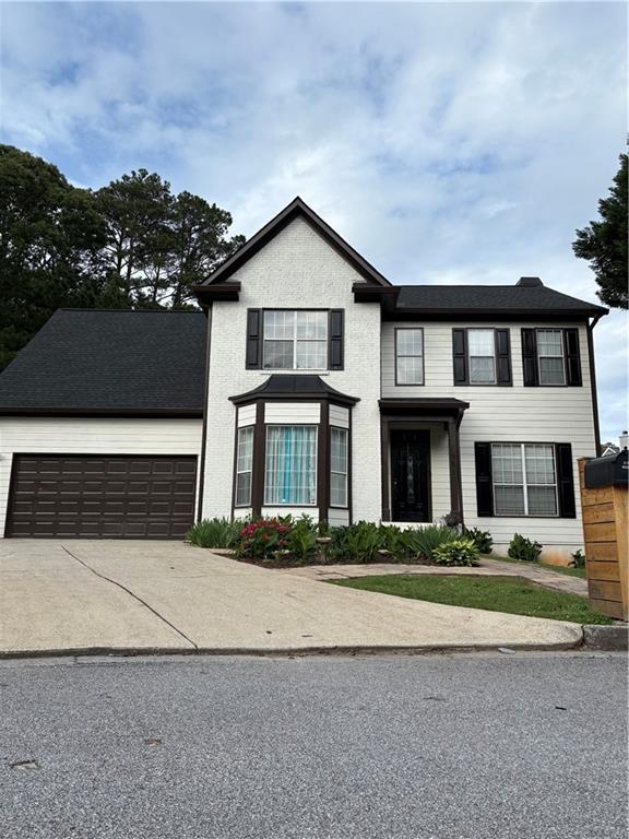 view of front of house with a garage and concrete driveway