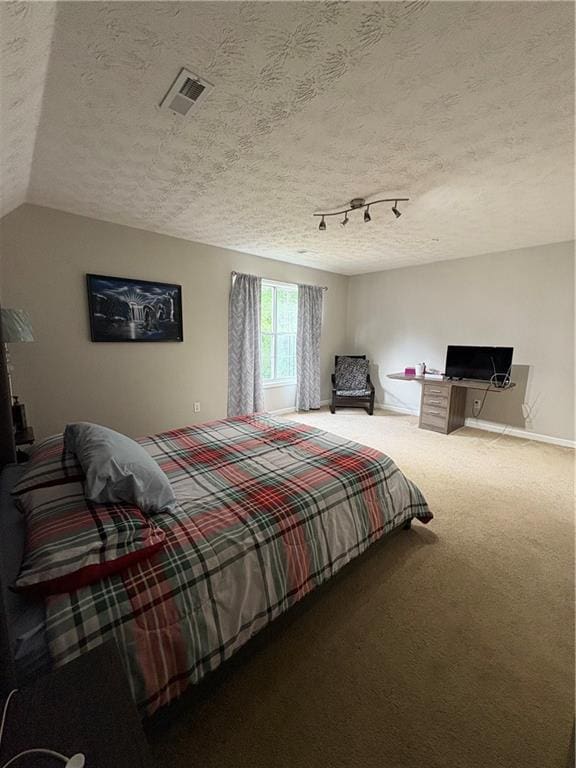 carpeted bedroom with a textured ceiling and lofted ceiling