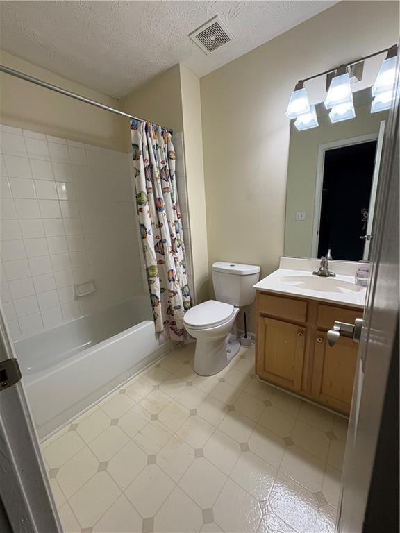 full bath featuring toilet, vanity, shower / bathtub combination with curtain, a textured ceiling, and tile patterned floors